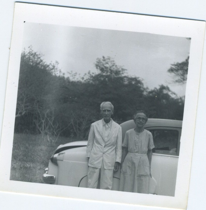 Elderly couple beside a car