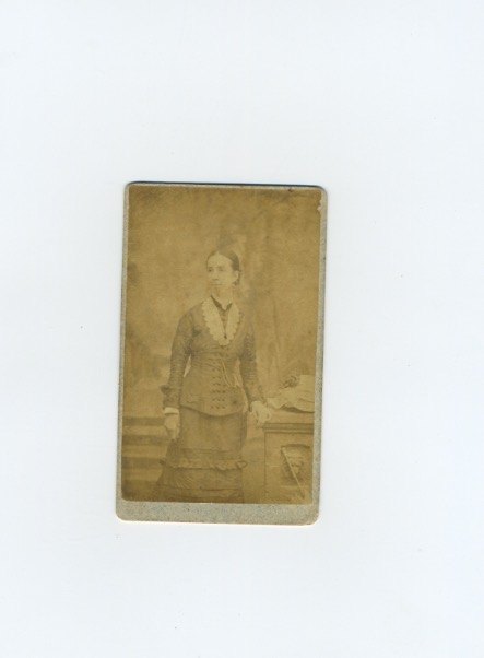 Young woman standing beside a table